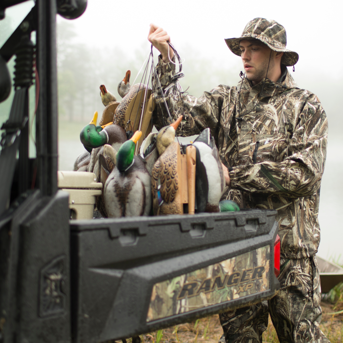 Firearms-Hunting_Ecom Carrying duck decoys wearing camo