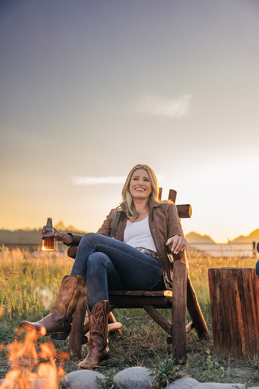 lady sitting in chair by fire